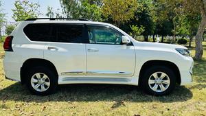 Toyota LandCruiser Prado TX  limited 2700cc (eco pro)
Model 2019/11 import  from japan April 2024 
Pearl white with beige leather interior 
Mileage  38000 km
Auction grade 4.5 A ( spotless condition)
7 seater  leather with sunroof 
Parktronic sensors & adopted Radar 
B&O sound system with 360 degrees cameras  front & rear 
Ambient lights
Wooden steering wheel  & full wooden interior 
Remote control smart starring & climate control access.
LED Xinon headlights with electric washers
Full body kit modilista & sport side skirts foot panels.
Crome package 
Full sports body kit available in the suv .
Further information please contact 11am to 10 pm & physically visit at Victory Cars jail road Lahore.