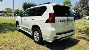 Toyota LandCruiser Prado TX  limited 2700cc (eco pro)
Model 2019/11 import  from japan April 2024 
Pearl white with beige leather interior 
Mileage  38000 km
Auction grade 4.5 A ( spotless condition)
7 seater  leather with sunroof 
Parktronic sensors & adopted Radar 
B&O sound system with 360 degrees cameras  front & rear 
Ambient lights
Wooden steering wheel  & full wooden interior 
Remote control smart starring & climate control access.
LED Xinon headlights with electric washers
Full body kit modilista & sport side skirts foot panels.
Crome package 
Full sports body kit available in the suv .
Further information please contact 11am to 10 pm & physically visit at Victory Cars jail road Lahore.