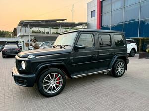 Mercedes Benz G63 AMG
V8 4.0 litre Biturbo
Model year 2020
Manufacturing Year 2019 end 
Fresh Import 2024
Milage 19000km 
Japan import
Satin black colour with red napa leather interior 


OPTIONS
•Active Lane Keeping Assist
•Red AMG brake callipers 
•Blind Spot Monitor
•Driver Assistance package Plus
•Smartphone integration CarPlay
•Sunroof
•Ambient lighting 
•Digital instrument cluster 
•360° camera
•Wider wheel arch for AMG wheels
•Parking package
•Switchable exhaust system
•AMG Performance steering wheel
•AMG Speedshift Plus 9G-Tronic
and many more options

Calling and Visiting Hours

Monday to Saturday

11:00 AM to 7:00 PM