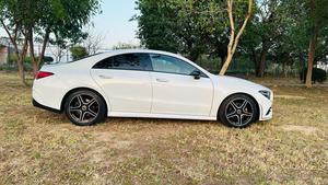 Mercedes-Benz CLA 200 sport back coupe sedan , ultimate AMG sport package 
1.6 cc twin turbocharged with 10 speed triptonic transmission.
Model 2021 registered Punjab 2022
Shahnawaz Pakistan import 
Mileage 18500 km
First owner vehicle 
Diamond white metallic colour with black two tone Dezine line AMG interior.
Bumper to bumper original condition & spotless.
Top of the line specs & customised options.
Glass panoramic electric sunroof 
Two tone leather AMG bucket seats
Multi power & 11 zone adjustment seat 
Heated & ventilated seats
8 zone climate control air conditioning 
Full dashboard single line  led cluster display.
64 colours ambient interior lighting 
Burdmaster pro premium surround sound system 
Multi 360 degree cameras 
Auto pilot 
Apple CarPlay & android apps
Electric multi zone massager seats 
Perfume air package 
Adapted Radar 
Adapted cruise control 
Line assisted & blind spot monitor 
Privacy glasses package 
All zone parktronic sensors access 
AMG suspension & break
Full AMG body kit
19” AMG alloy wheels 
Duel AMG mufflers
Further information please call & visit at Victory Cars Lahore.