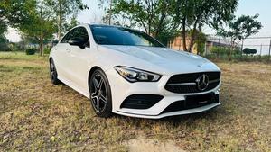 Mercedes-Benz CLA 200 sport back coupe sedan , ultimate AMG sport package 
1.6 cc twin turbocharged with 10 speed triptonic transmission.
Model 2021 registered Punjab 2022
Shahnawaz Pakistan import 
Mileage 18500 km
First owner vehicle 
Diamond white metallic colour with black two tone Dezine line AMG interior.
Bumper to bumper original condition & spotless.
Top of the line specs & customised options.
Glass panoramic electric sunroof 
Two tone leather AMG bucket seats
Multi power & 11 zone adjustment seat 
Heated & ventilated seats
8 zone climate control air conditioning 
Full dashboard single line  led cluster display.
64 colours ambient interior lighting 
Burdmaster pro premium surround sound system 
Multi 360 degree cameras 
Auto pilot 
Apple CarPlay & android apps
Electric multi zone massager seats 
Perfume air package 
Adapted Radar 
Adapted cruise control 
Line assisted & blind spot monitor 
Privacy glasses package 
All zone parktronic sensors access 
AMG suspension & break
Full AMG body kit
19” AMG alloy wheels 
Duel AMG mufflers
Further information please call & visit at Victory Cars Lahore.