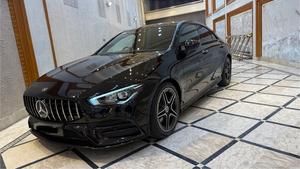 Mercedes-Benz CLA200  AMG -S ( twin turbocharged ) night black package 
Model 2021 registered 2022 in Islamabad 
Shahnawaz import.
Pearl black metallic with twin shadesd Dezine line AMG leather interior 
Mileage 24000 km
Bumper to Bumper original & spotless condition 
Top of line customised specs. 
Memory package, 14 electric power seats ejectment , heated & ventilated seats 
AMG spot bucket seat 
Multi zone climate control air conditioning 
Burmaster pro. surround sound entertainment system 
Panoramic electric sunroof 
Head up display 
Multi massager seats package 
Telescopic electric steering wheel 
Paddle shifter 
Adapted cruise controls 
Radar & adapted line accessed 
360 degrees cameras 
Multi zone auto parktronic package 
64 colours ambient lights interior 
Perfume package 
Multi driving modes eco, individual, sport, sport + & comfort.
Privacy glass package 
AMG sport suspension 
Wireless charger 
Wireless Apply CarPlay & android apps 
AMG muffler with change sound 
19 “ AMG sport alloy wheels 
Full AMG body kitted 
GT line front grill
Flat screen o led smart cluster 
Adapted led laser headlights 
Further information please call & visit at Victory Cars jail road Lahore.